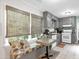 Kitchen features a breakfast nook with window seating, gray cabinetry and tile flooring at 7370 N Mitchell Ct, Villa Rica, GA 30180