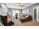 Living room features neutral colors, a brown sectional, and ample natural light at 7370 N Mitchell Ct, Villa Rica, GA 30180