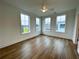 Well-lit bedroom featuring hardwood floors, ceiling fan and three windows at 919 Hughley Circle # 72, Atlanta, GA 30316