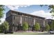 Modern brick townhome with balconies, large windows, and manicured lawn at 919 Hughley Circle # 72, Atlanta, GA 30316