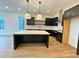Modern kitchen featuring black cabinets, stainless steel appliances, and center island at 919 Hughley Circle # 72, Atlanta, GA 30316