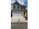 Charming two-story home with gray siding, white brick accents, and a spacious two car garage at 1058 Crest Mill Dr, Marietta, GA 30008