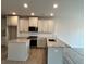 Bright kitchen boasts granite counters, an island, and modern stainless steel appliances at 1058 Crest Mill Dr, Marietta, GA 30008