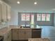 Bright and airy kitchen with granite countertops, island, and stainless steel dishwasher at 1058 Crest Mill Dr, Marietta, GA 30008