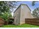 Exterior side view features a wooden fence, a small deck, and green lawn at 107 Providence Run, Dallas, GA 30157