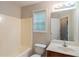 Bathroom featuring a bathtub with a shower, a single vanity, and a window for natural light at 107 Providence Run, Dallas, GA 30157
