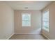 Well-lit bedroom with neutral walls, carpeted floor and two windows at 107 Providence Run, Dallas, GA 30157