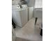 A bright laundry room featuring appliances and tile flooring at 107 Providence Run, Dallas, GA 30157