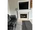 Elegant living area features a fireplace with decorative mantel, TV, and comfortable seating at 107 Providence Run, Dallas, GA 30157