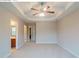 The spacious main bedroom with carpet flooring, tray ceiling, and ensuite bathroom at 107 Providence Run, Dallas, GA 30157