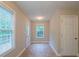 Bright sunroom with tile flooring, a garden view window, and access doors, creating a versatile space at 107 Providence Run, Dallas, GA 30157