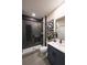 Modern bathroom featuring a glass enclosed shower with black fixtures and dark subway tile at 3470 Austin Michael Ln, Cumming, GA 30028