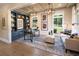 Well-lit home office with custom built-ins, a desk, and comfortable seating area at 3470 Austin Michael Ln, Cumming, GA 30028