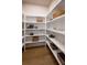 Well-organized pantry with ample shelving for storage and hardwood flooring at 3470 Austin Michael Ln, Cumming, GA 30028