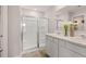 Modern bathroom featuring double sinks, a glass-enclosed shower, and contemporary fixtures at 358 Friendship Oak Way, Hampton, GA 30228