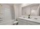A bright bathroom with double sinks, a large mirror, and a shower/tub combo creating a clean and functional space at 358 Friendship Oak Way, Hampton, GA 30228