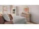 Bright bedroom featuring a comfortable bed, soft pink accents, and a sunburst mirror creating a cozy and inviting atmosphere at 358 Friendship Oak Way, Hampton, GA 30228