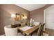 Comfortable dining room featuring a rustic wood table, six chairs, complementary lighting, and a charming ambiance at 358 Friendship Oak Way, Hampton, GA 30228