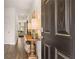 Inviting entryway showcasing a dark wood door, hardwood floors, console table, and a glimpse of the bright living room at 358 Friendship Oak Way, Hampton, GA 30228