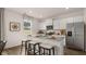 Elegant kitchen with an island bar, stainless steel appliances, and modern cabinetry with hardwood floor at 358 Friendship Oak Way, Hampton, GA 30228