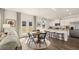 Open-concept living area flowing into the kitchen, featuring hardwood floors and natural light from the doors at 358 Friendship Oak Way, Hampton, GA 30228