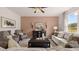 Bright living room features neutral tones, plush seating, stylish decor, and ample natural light at 358 Friendship Oak Way, Hampton, GA 30228