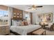 Comfortable main bedroom with a ceiling fan, stylish decor, and windows with wooded backyard views at 358 Friendship Oak Way, Hampton, GA 30228