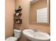 Modern powder room with a stylish pedestal sink, framed mirror, and decorative shelves for added character at 358 Friendship Oak Way, Hampton, GA 30228
