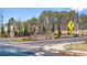 Oakchase at Hampton community entrance with brick signage, landscaping, and directional signs under a sunny sky at 358 Friendship Oak Way, Hampton, GA 30228