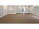 Finished basement space with neutral carpet and archway leading to another room at 4335 Northwind Dr, Ellenwood, GA 30294