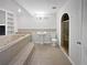 Large primary bathroom featuring a jacuzzi tub, vanity and separate shower at 4335 Northwind Dr, Ellenwood, GA 30294
