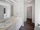 Bright bathroom featuring double sinks, white cabinets, and a walk-in closet at 4335 Northwind Dr, Ellenwood, GA 30294