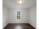 Well-lit bedroom featuring wood flooring, neutral wall color, and a single window offering natural light at 4335 Northwind Dr, Ellenwood, GA 30294