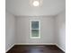 Bright bedroom features a window with natural light and dark wood floors at 4335 Northwind Dr, Ellenwood, GA 30294