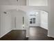 Grand entryway featuring arched doorways, modern chandelier, wainscoting, and gleaming hardwood floors at 4335 Northwind Dr, Ellenwood, GA 30294