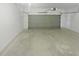 A spacious, empty two car garage with painted walls and concrete flooring at 4335 Northwind Dr, Ellenwood, GA 30294