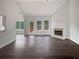 Bright living room with fireplace, hardwood floors, and large windows bringing in natural light at 4335 Northwind Dr, Ellenwood, GA 30294