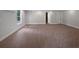 Spacious basement living room with a window, mini-split, and neutral carpet at 4335 Northwind Dr, Ellenwood, GA 30294