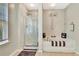 Bathroom featuring walk-in shower, soaking tub, modern fixtures, and natural light at 2951 Edgewater St, South Fulton, GA 30331