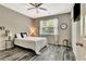 Bedroom with ceiling fan, a large window with curtains, hardwood floors and side tables at 2951 Edgewater St, South Fulton, GA 30331