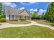 Community clubhouse with a well-kept lawn, sidewalks, and beautiful flowers at 2951 Edgewater St, South Fulton, GA 30331