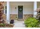 Front porch detail showing stone accents, a wreath on the door, and lush green landscaping at 2951 Edgewater St, South Fulton, GA 30331