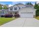 Inviting two-story home featuring a well-kept lawn, landscaped bushes, and attached two-car garage at 2951 Edgewater St, South Fulton, GA 30331