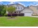 Well-maintained two-story home with lush green lawn, attractive landscaping, and a two-car garage at 2951 Edgewater St, South Fulton, GA 30331
