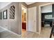Hallway featuring decorative wall art leading to the bathroom on the left and bedroom/office on the right at 2951 Edgewater St, South Fulton, GA 30331