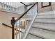 Carpeted staircase with white banisters and a dark wood handrail at 2951 Edgewater St, South Fulton, GA 30331