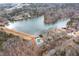 Scenic aerial view of lakefront property with community pool, tennis courts, and lush surroundings at 3205 Brandywine Nw Pl, Marietta, GA 30064