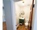 Small bathroom with decorative mirror, green vanity, wood floors, and neutral walls at 3205 Brandywine Nw Pl, Marietta, GA 30064
