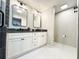 Bathroom features white cabinets, double vanity, modern lighting, and hexagon tile floors at 3205 Brandywine Nw Pl, Marietta, GA 30064