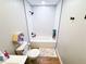 Narrow bathroom featuring subway tile walls, with tub/shower combo, toilet and small shelf at 3205 Brandywine Nw Pl, Marietta, GA 30064